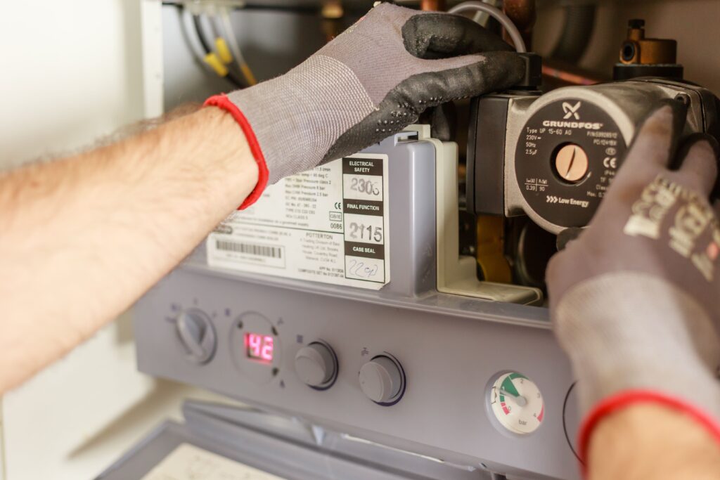 Hands Adjusting A Boiler System